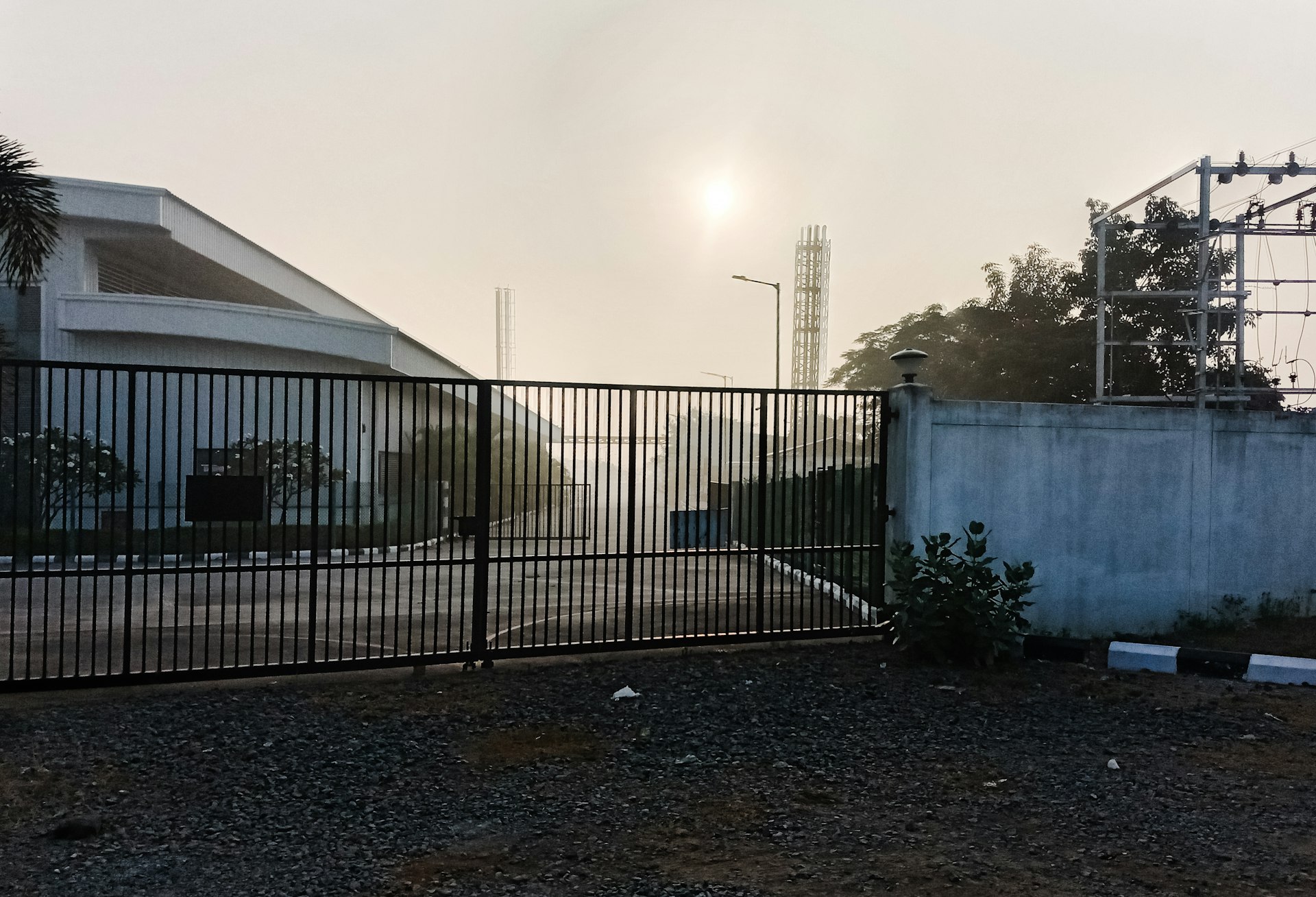 a fenced in area with a building in the background